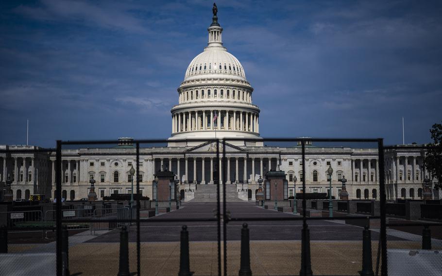 Fencing, erected after the Jan. 6 riot, is seen surrounding the Capitol building in Washington on July 9, 2021.