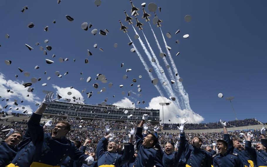 As the U.S. Air Force Thunderbirds fly overhead, cadets celebrate at their graduation ceremony at the Air Force Academy in Colorado, May 25, 2022.