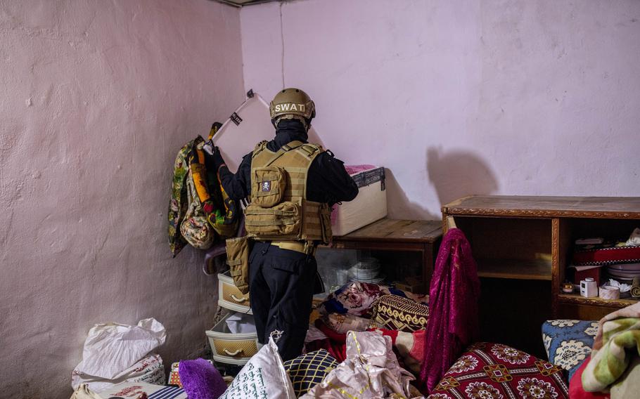 Officers of an anti-drug unit search the house of a drug dealer in Basra on Aug. 18.