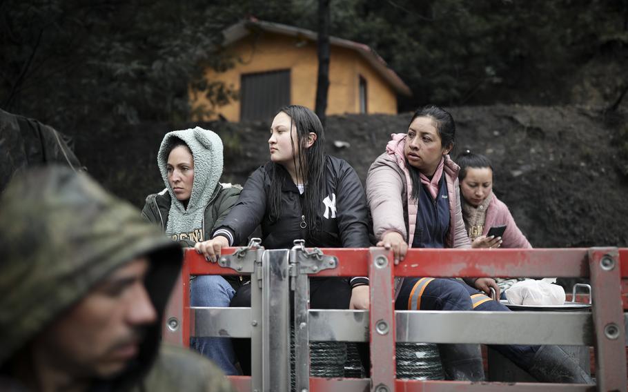 Neighbors and relatives wait for news of miners at a coal mine affected by an explosion that, according to authorities, killed at least 11 people in Sutatausa, in the Cundinamarca province of Colombia, Wednesday, March 15, 2023.