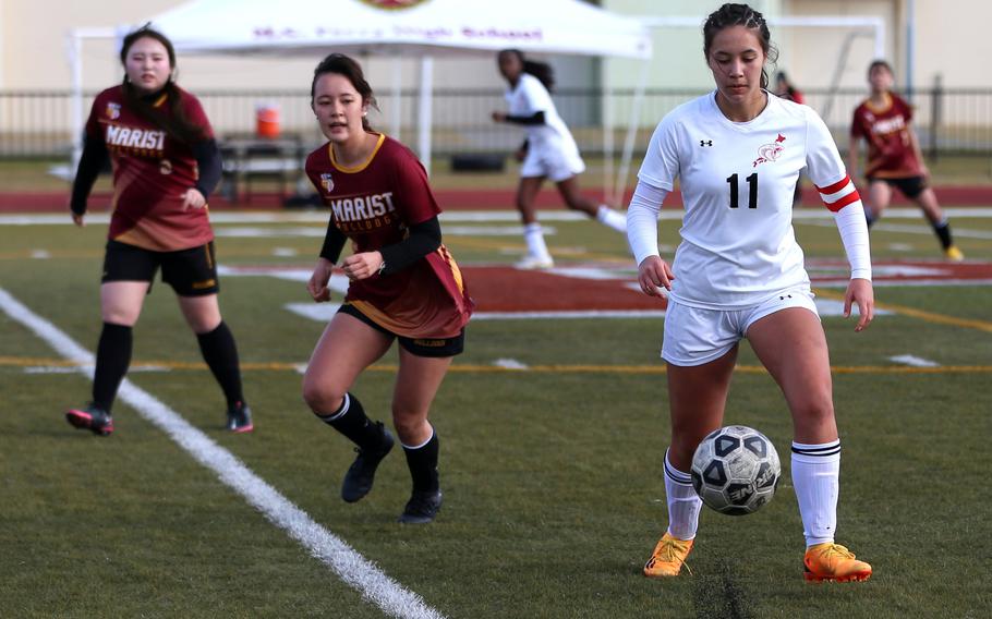 E.J. King’s Maliwan Schinker plays the ball off the turf against Marist Brothers during Friday’s Western Japan Athletic Association girls soccer tournament. The Cobras won 3-2. Schinker kicked the winning goal in last year’s tournament to help the Cobras capture the title.