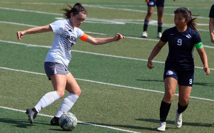 Humphreys' Claire Anderson plays the ball against Osan's Clarice Lee during Saturday's DODEA-Korea girls soccer match. The Blackhawks won 6-2.