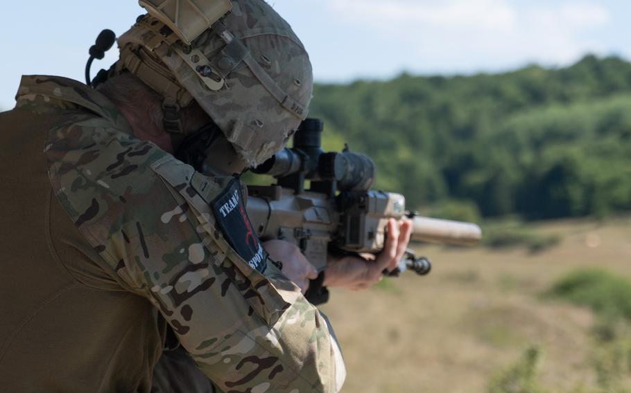 A U.S. soldier locates targets during the European Best Sniper Team Competition at Hohenfels Training Area in Germany on Aug. 8, 2022. Service members from 18 countries are vying for the title of best sniper in Europe.