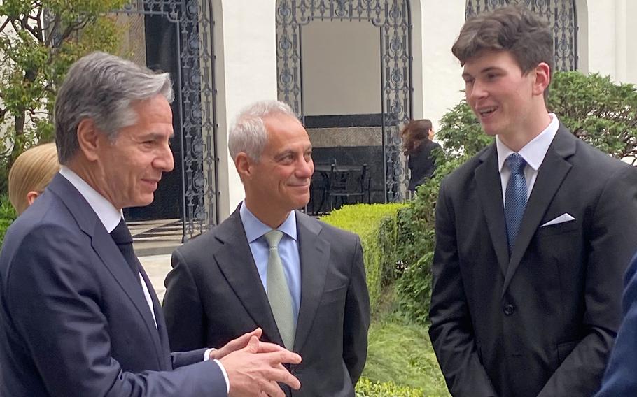 Military teen Aiden O'Reilly discusses his G-7 summit experience with Secretary of State Anthony Blinken, left, and U.S. Ambassador to Japan Rahm Emanuel, center, at the embassy in Tokyo, April 18, 2023.