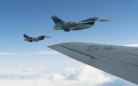 Two U.S Air Force F-16  Fighting Falcons assigned to the 18th Aggressor Squadron, Eielson Air Force Base, Alaska, fly beside a KC-135 Stratotanker to refuel while conducting a mission for RED FLAG-Alaska 19-2, June 14, 2019. The 18th Aggressor Squadron prepares combat Air Force, joint and allied aircrews through challenging, realistic threat replication, training, test support, academics and feedback. RF-A is a Pacific Air Forces-sponsored exercise designed to provide realistic training in a simulated combat environment. (U.S. Air Force photo by Master Sgt. Burt Traynor)