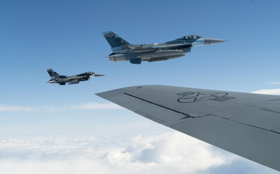 Two Air Force F-16 Fighting Falcons assigned to the 18th Aggressor Squadron at Eielson Air Force Base, Alaska, fly beside a KC-135 Stratotanker to refuel while conducting a mission in June 2019. 