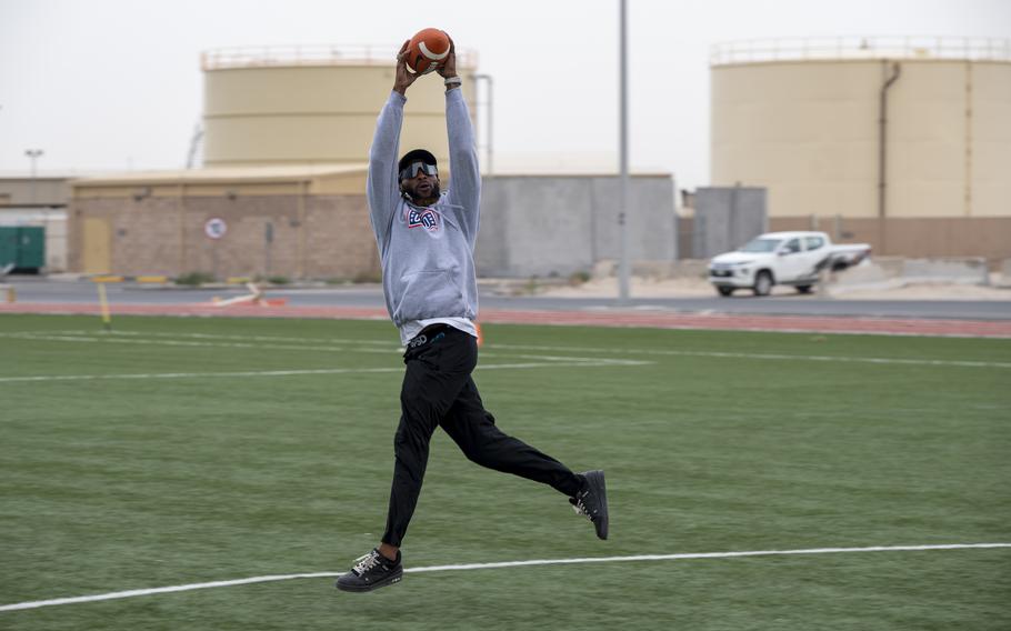 Aaron Jones catches a football in the air