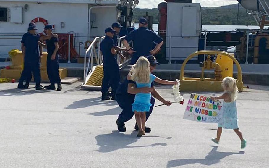 Family members welcome the crew of the new Coast Guard cutter Frederick Hatch upon arrival at its homeport on Guam, Tuesday, June 29, 2021.