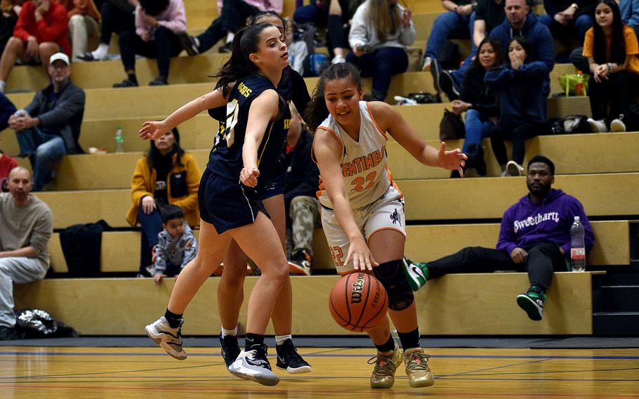 Spangdahlem freshman Jayda Lewis dribbles along the baseline while Ansbach junior Abecca Ackles defends during a Division III semifinal at the DODEA European Basketball Championships on Feb. 16, 2024, at Wiesbaden High School in Wiesbaden, Germany.