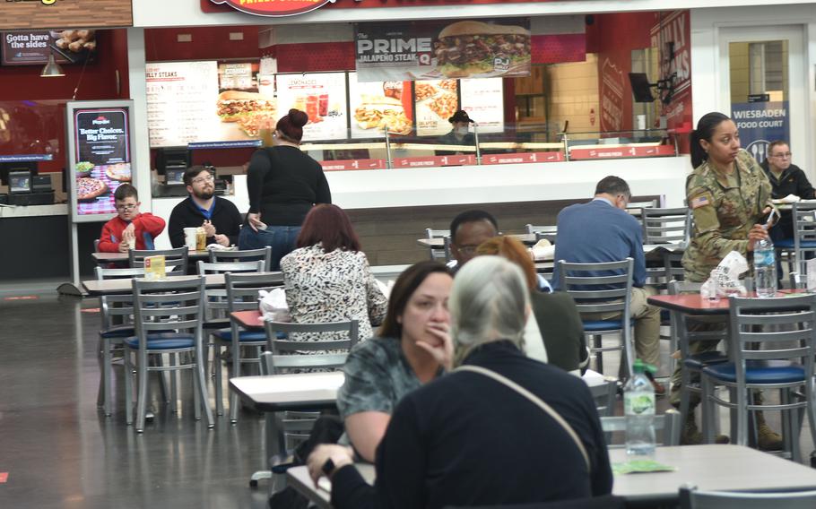 People eat at the exchange food court on post in Wiesbaden, Germany, March 3, 2022. Eating used to be one of the few exceptions for people to go maskless indoors until recently, when the Army garrison dropped the requirement for vaccinated people in most places. 