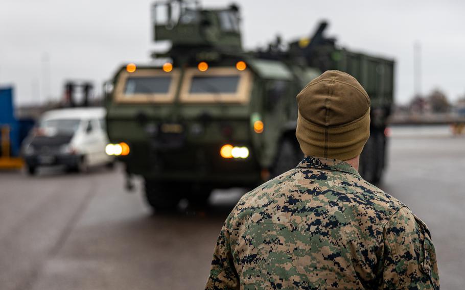 A U.S. Marine with Combat Logistics Battalion 6, Combat Logistics Regiment 2, 2nd Marine Logistics Group, guides vehicles during Freezing Winds 23 at Hanko, Finland, Oct. 31, 2023. The Finnish-led maritime exercise practices cooperation among NATO partners. 