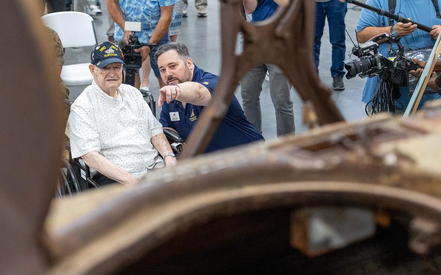 A man points to a tank.
