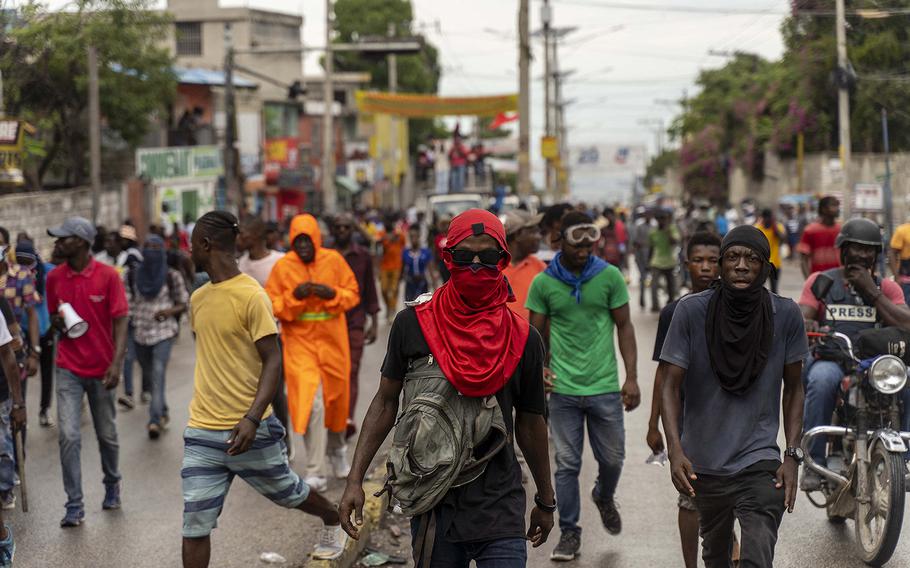 Demonstrators protest to reject an international military force requested by the government in Port-au-Prince, Haiti, on Oct. 24, 2022. 