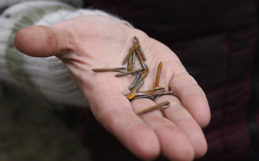 Svitlana Chmut holds fléchettes, small arrow-like projectiles dispersed by a Russian artillery shell, in Bucha, Ukraine, on April 16, 2022.