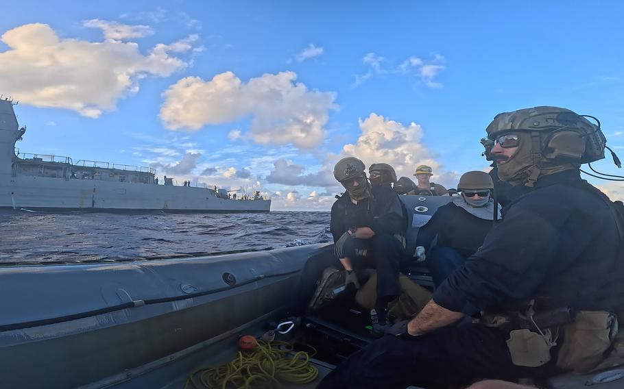 Service members sit on a boat together