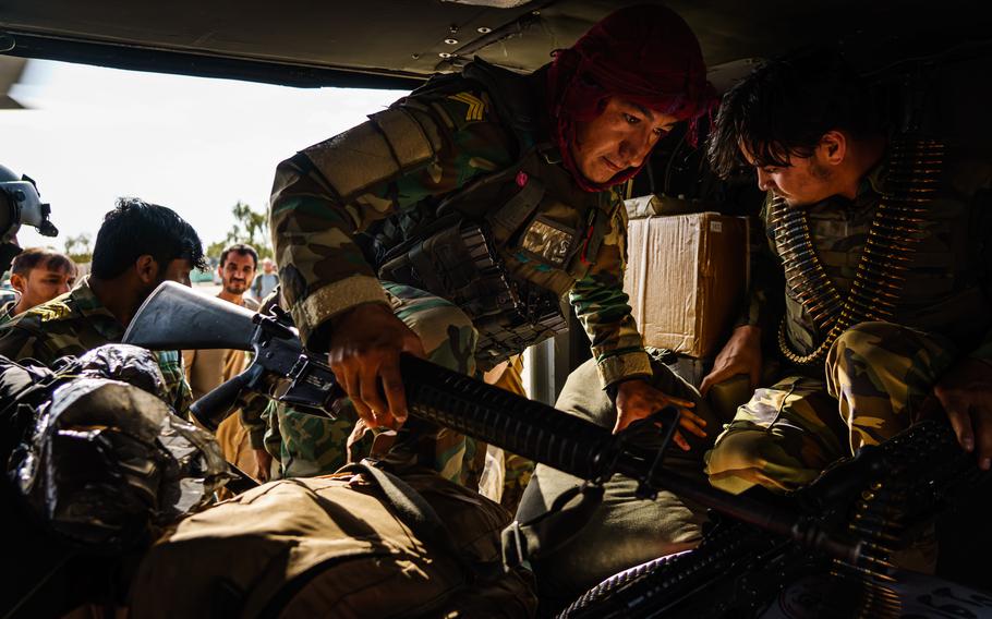 Soldiers board a UH-60 Blackhawk for a resupply mission to an outpost north of Kandahar, Afghanistan. 