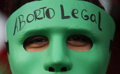 FILE - An abortion-rights activist wears a mask with text that reads in Spanish "Legal Abortion" during a rally outside Congress as lawmakers debate a bill that would legalize abortion, in Buenos Aires, Argentina, Tuesday, Dec. 29, 2020. In Argentina, lawmakers in late 2020, passed a bill legalizing abortion until the 14th week. 