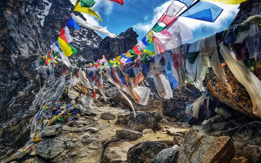 Prayer flags are strung across the summit of Renjo La Pass in the Himalayas. 