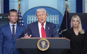 Trump speaks at a microphone, with Hegseth and Bondi flanking him.