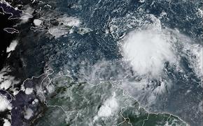 This satellite image provided by NOAA on Monday, Oct. 2 2023 shows Tropical Storm Philippe, center right. Philippe is threatening to unleash heavy rains and flash flooding in the Leeward Islands on Monday before eventually recurving out into the central Atlantic where it could gain hurricane status around midweek, forecasters say.