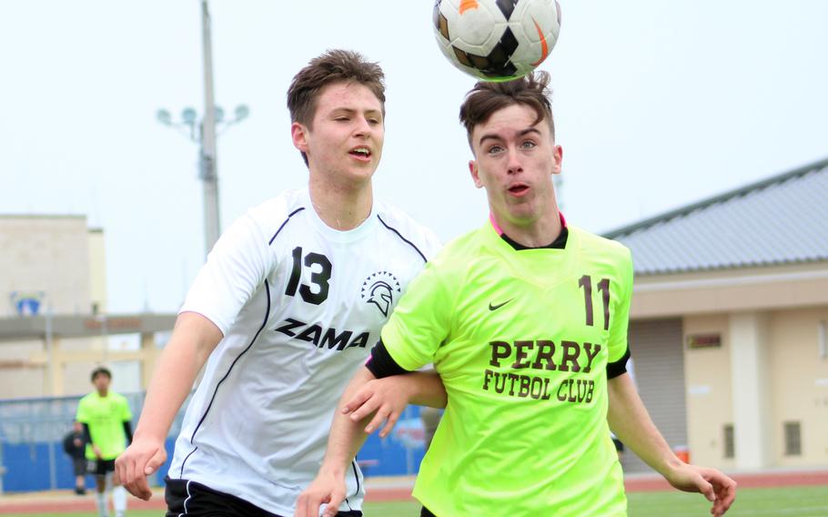 Matthew C. Perry’s James Williams heads the ball against Zama’s Kris Brush during Friday’s Perry Cup boys soccer tournament matches. The Trojans won 1-0.