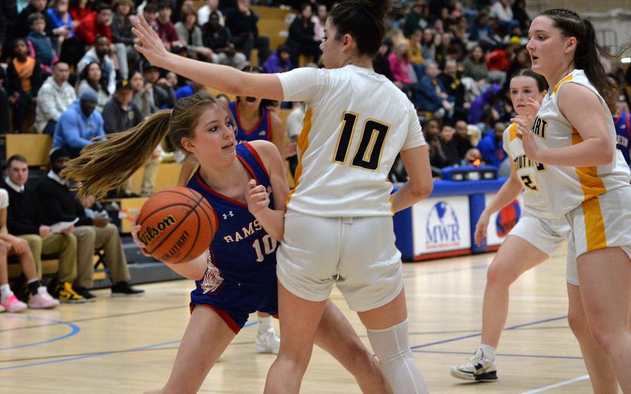 Ramstein’s Charlotte Rhyne looks for a teammate past Stuttgart’s Mia Snyder in the girls Division I final at the DODEA-Europe basketball championships in Wiesbaden, Germany, Feb. 17, 2024. Stuttgart took the DI title with a 33-26 win.