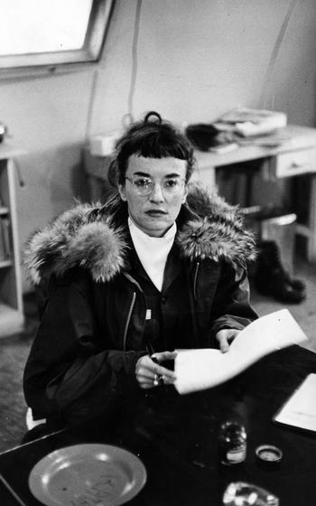 A woman sits in a parka