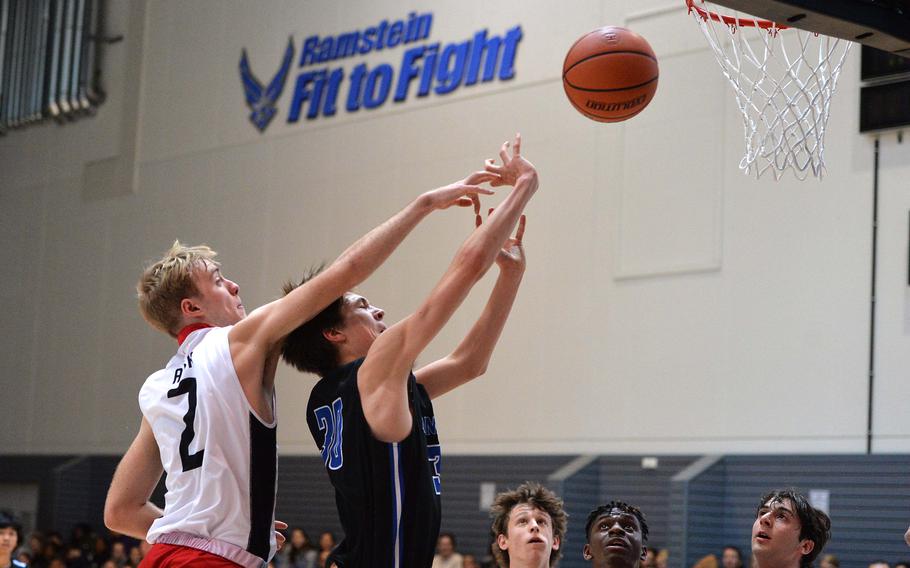 AOSR’s Parker Huber reaches in an attempt to block a shot by Rota’s Hampton Brasfield in a Division II semifinal at the DODEA-Europe basketball championships in Ramstein, Germany, Feb. 17, 2023. Rota won 59-51 to advance to the championship game against Naples.