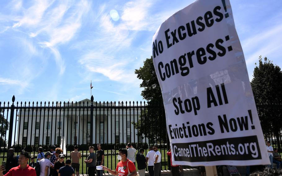 Demonstrators hold placards in front of the White House in Washington, D.C., Sept. 25, 2021, to call for the cancellation of rents and mortgages, and to prevent millions of evictions in the middle of a resurgence of the COVID-19 pandemic. 