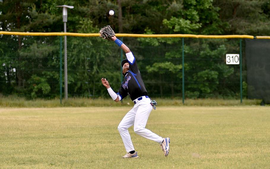 Ramstein shortstop Christian Roy goes into left field to catch a fly ball during the Division I final against Kaiserslautern at the 2025 DODEA European baseball championships on May 23, 2025, at Southside Fitness Center on Ramstein Air Base, Germany.