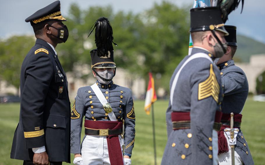 Kasey Meredith, center, is installed as the first woman to command the Corps of Cadets at Virginia Military Institute during a May 14 ceremony at the school in Lexington.