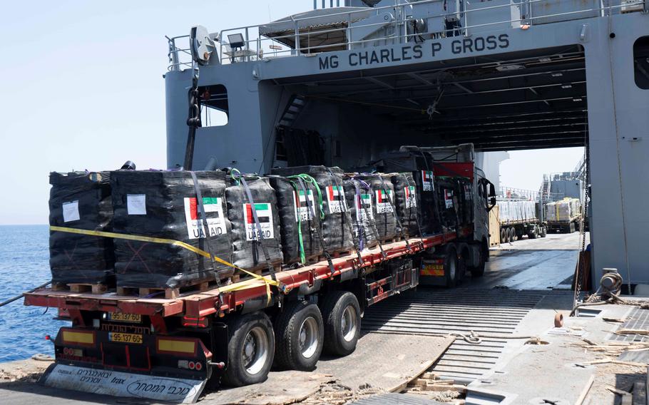 A driver transports pallets of humanitarian aid on June 14, 2024, from the USNS GySgt Fred W. Stockham across a floating platform and onto an Army vessel off the coast of Gaza.