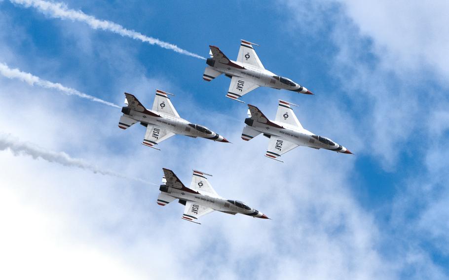 Four airplanes fly together in the sky.