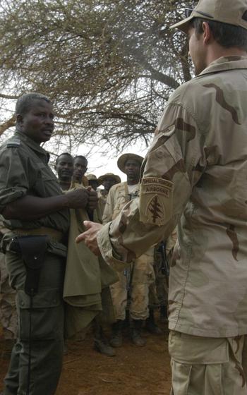 A Green Beret from the Stuttgart, Germany-based 1st Battalion, 10th Special Forces Group, right, and a Nigerien officer discuss foot-patrol tactics during training in Tahoua, Niger.