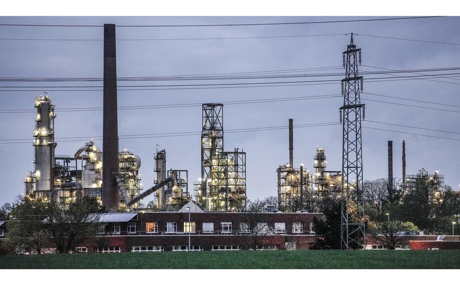 A Shell chemical plant is illuminated in Wesseling, near Cologne, Germany, on April 6, 2022. Germany says it is making progress on weaning itself off Russian fossil fuels and expects to be fully independent of crude oil imports from Russia by late summer.