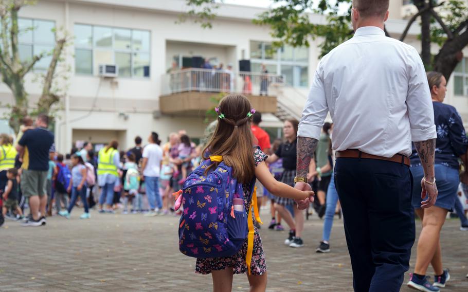 Students and parents gather outside Sullivans Elementary School ahead of the first day of classes at Yokosuka Naval Base, Japan, Monday, Aug. 22, 2022.