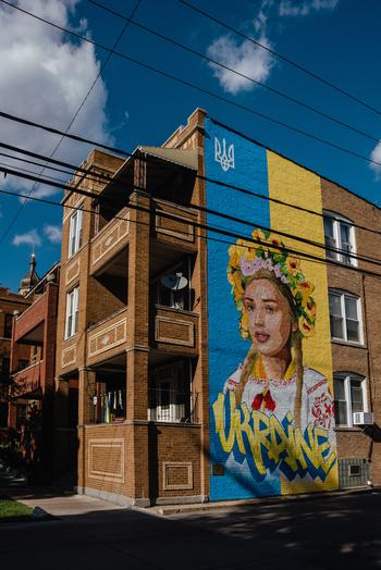 A large mural of a Ukrainian woman is painted on the side of an apartment building in Chicago's Ukrainian Village. 