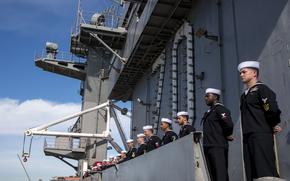 Sailors of the USS Carl Vinson line the rails as the carrier returns to port in February 2024. The ships is named for the powerful former congressman known for championing the Navy while opposing racial desegregation.