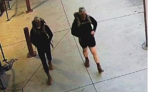 Two men are seen in security footage wearing backpacks, hats, masks and combat boots.