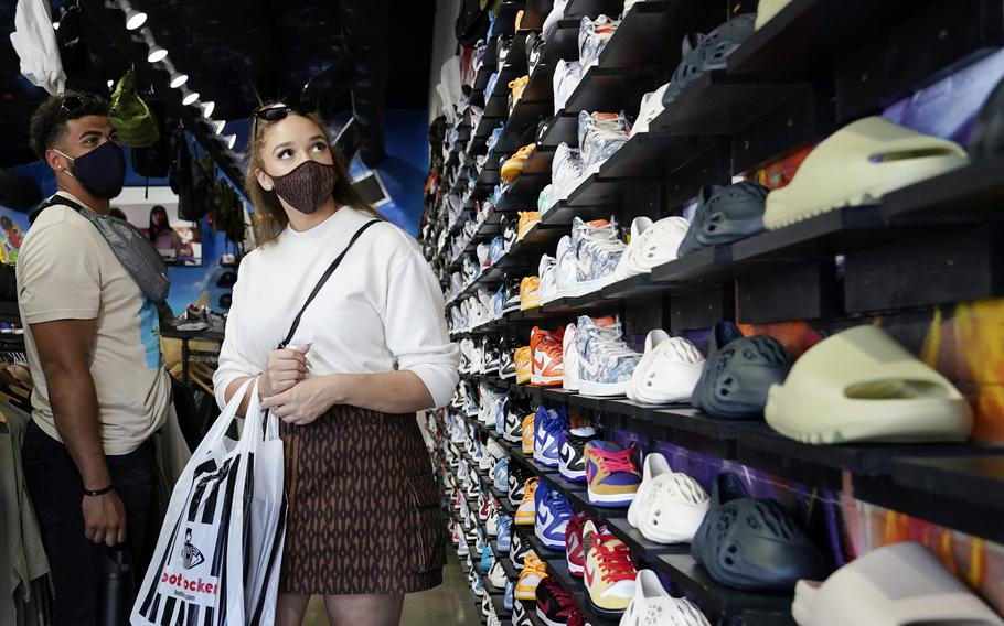 Shoppers wear masks inside of The Cool store Monday, July 19, 2021, in the Fairfax district of Los Angeles. Los Angeles County has reinstated an indoor mask mandate due to rising COVID-19 cases.