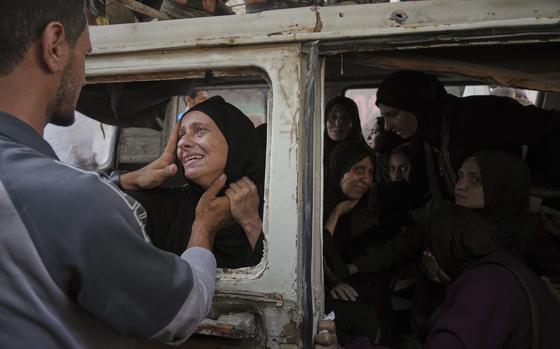 A man holding the face of a crying woman.