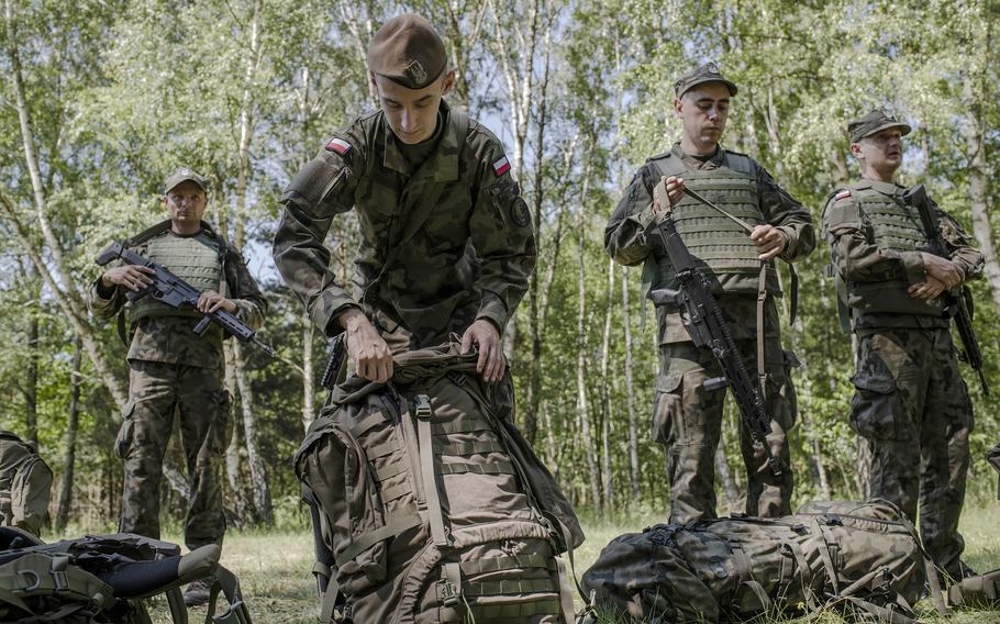 A recruit repacks his gear during 16 days of military training in northern Poland. 