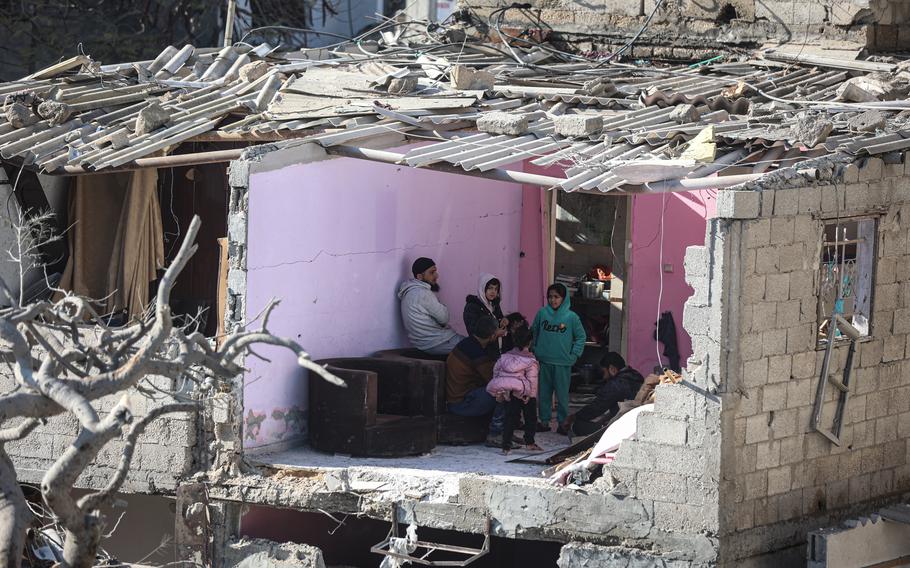 A Palestinian family inspects their destroyed home after an Israeli airstrike in Rafah, southern Gaza, in late-February.