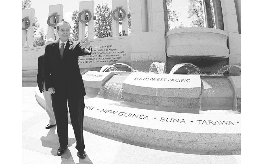 Former Senate Majority Leader Bob Dole gestures while leading members of Congress on a tour of the World War II Memorial in Washington on April 27, 2004. 