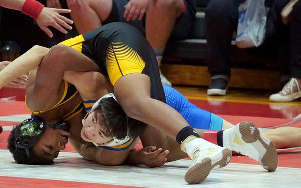 Kadena's Josiah Drummer, a freshman, works a technical-fall victory over St. Mary's Jong In Lee in the 108-pound Far East final.