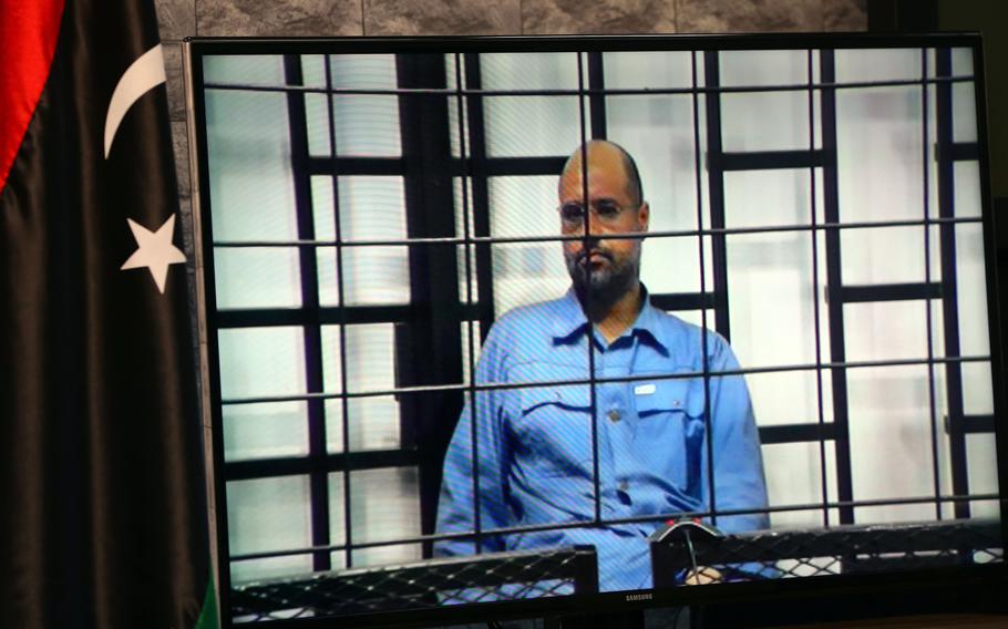 A screen inside a room in Tripoli on June 22, 2014, shows Seif al-Islam Gadhafi, the son of slain Libyan dictator Moamer Gadhafi, taking questions from a panel of judges as the interview was broadcasted live from Zintan, Libya.