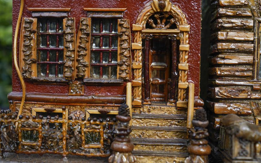 A miniature brownstone building is displayed during preparations for the annual Holiday Train Show at the New York Botanical Garden in New York, Thursday, Nov. 11, 2021. The show, which opens to the public next weekend, features model trains running through and around New York landmarks, recreated in miniature with natural materials. 