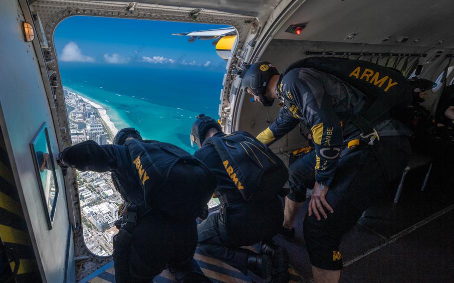 Soldiers prepare to jump out of an aircraft
