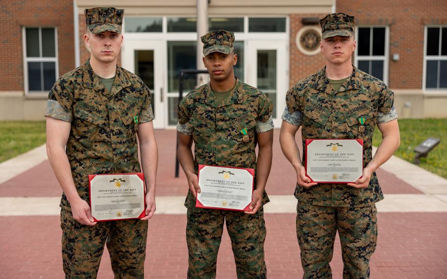 U.S. Marine Corps Corporal Bradley Feldkamp, a motor transport operator, left, Lance Corporal Nicholas Dural, an infantry rifleman, center, and Corporal John Darby, a flight equipment technician, right, all attending Marine Security Guard School at Marine Corps Embassy Security Group, pose for a photo after receiving the Navy and Marine Corps Achievement Medal for heroic acts performed while off-duty after an awards ceremony on Quantico, Virginia, April 6, 2023. The Marines received the award after intervening during an altercation between civilians involving a knife. The Marines successfully deescalated the situation, recovered the weapon and restrained the perpetrators until the police arrived on scene. 