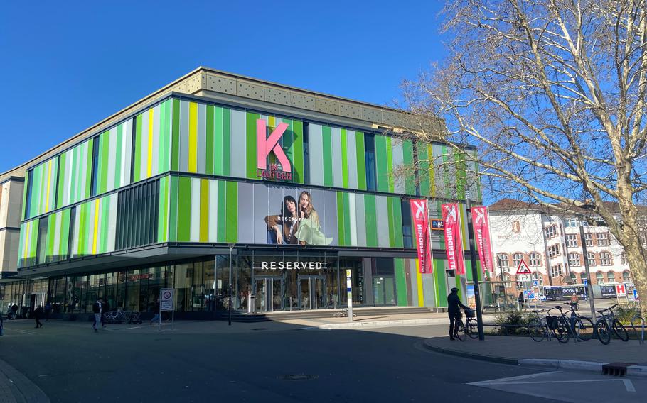The exterior  of K in Lautern features a large pink K logo, the front of the Reserved store, and gray and green stripes.